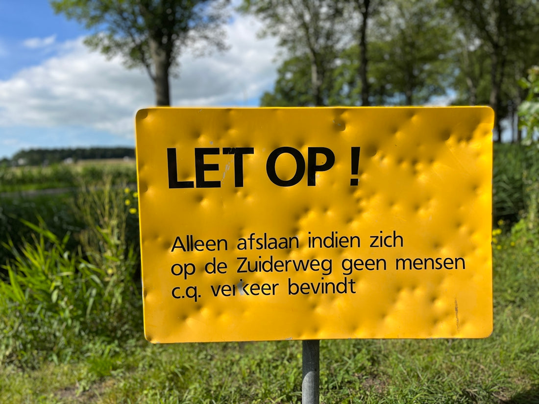a yellow sign in a field