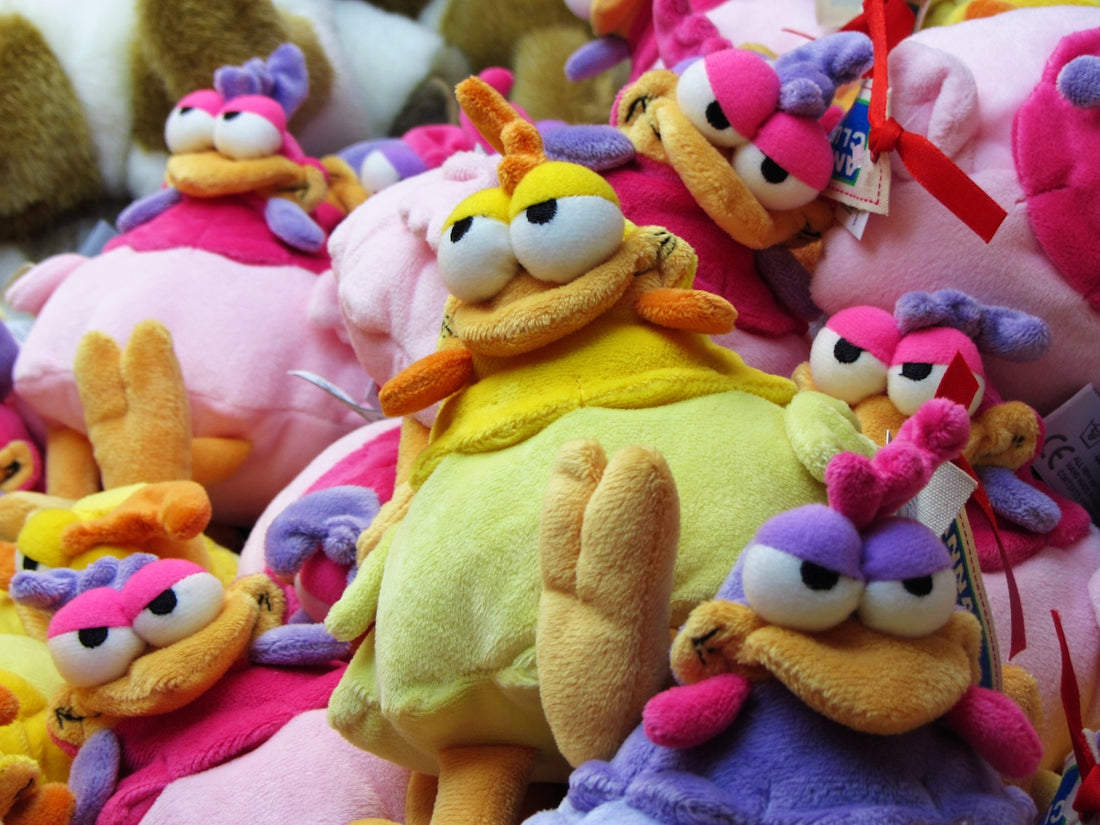 A pile of colorful stuffed cartoon bird toys.