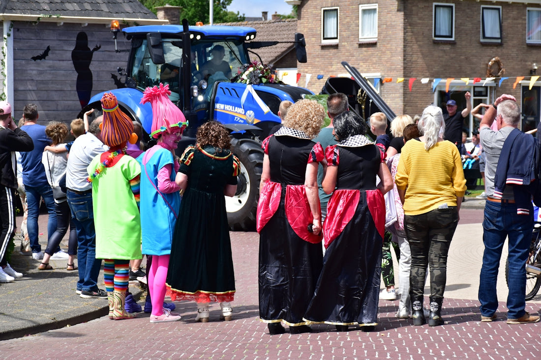 Children in costumes with a tractor in background