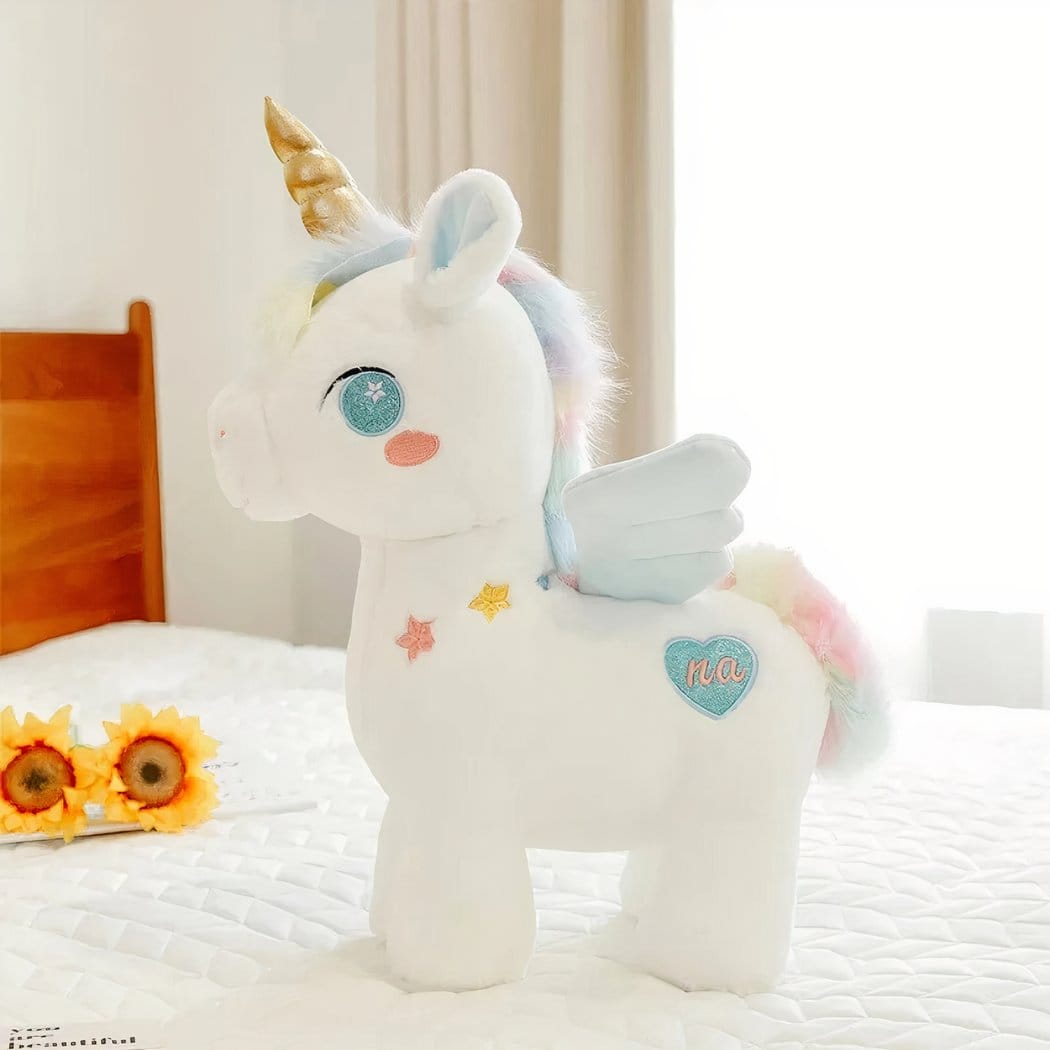 Schattige Eenhoornknuffel Met Gouden Hoorn En Regenboogvleugels De Knuffel blauw